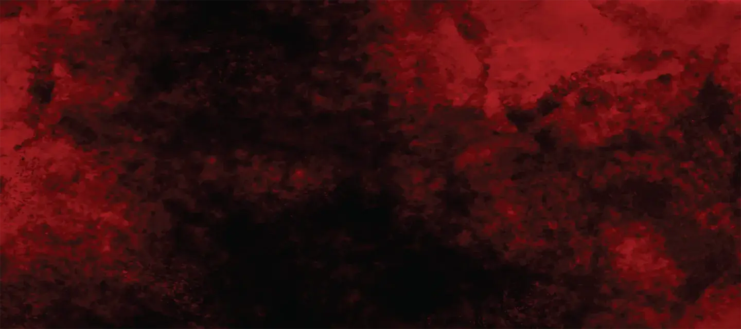 A blotchy dark surface under red light